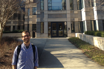 Joshua Rivenbark stands in front of the Sanford School of Public Policy at Duke (before the COVID-19 pandemic).