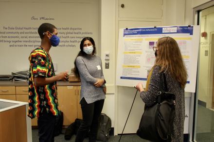 From left to right, students Arthi Vaidyanathan and Muhammed Bah discuss their project during the Fall 2021 Global Health Undergraduate Capstone Poster Presentations event in Trent Hall. 