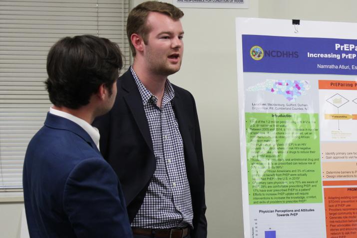 students presenting poster