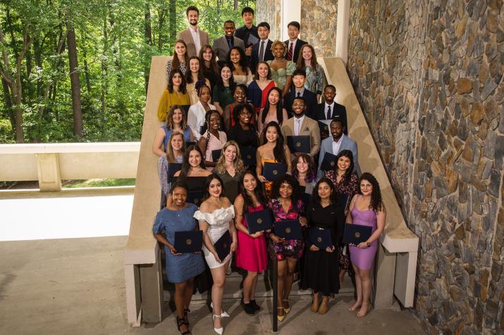 students smiling on steps