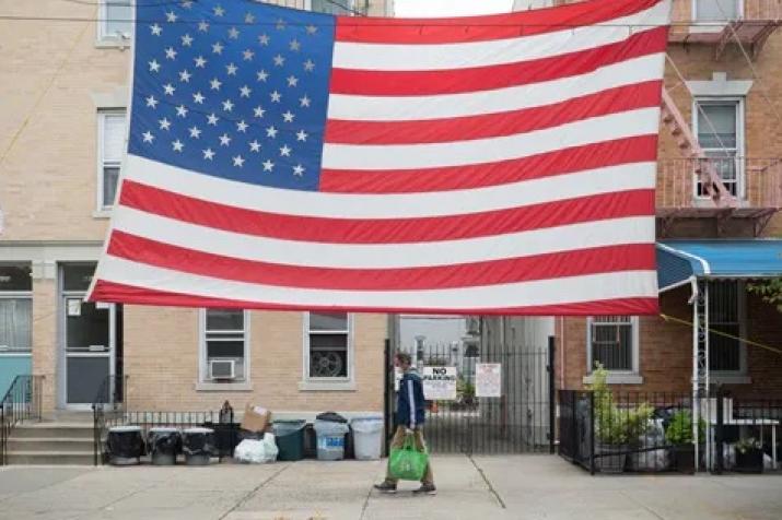 US flag hanging over street