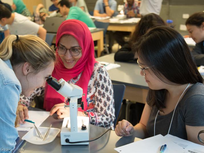 One Health Trainees View Mosquito in Microscope