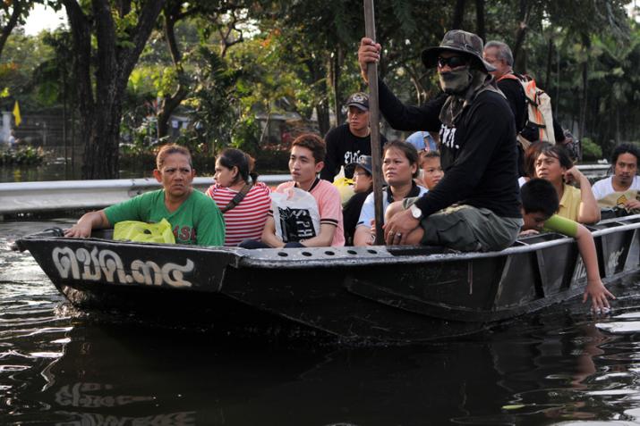 An army boat ferries flood victims to safety on a flooded road in Pinklao district, Bangkok, Thailand on November 4, 2011.