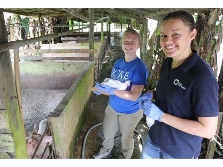 Sarah and Laura Getting Pig Samples