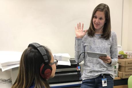 Samantha Kleindienst Robler conducts a hearing evaluation with a child