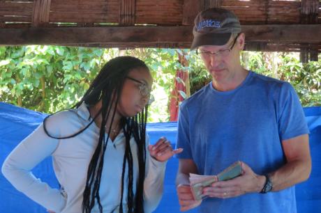 Charles Nunn reviews information with a student in the field
