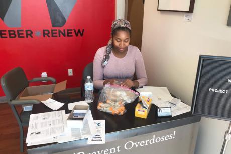 Autumn Barnes sits at the front desk of Project Weber/RENEW assembling Narcan kits.