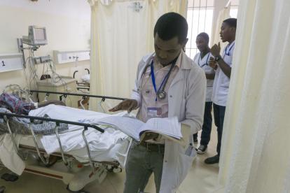 A doctor sees a patient in the KCMC emergency department