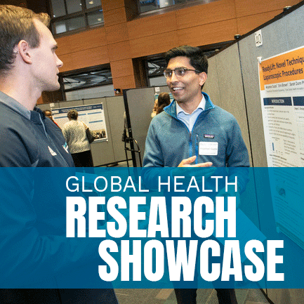 Male student standing in front of research poster presenting to a man